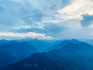 Beautiful alpine landscape with mountain range silhouette. Mountain peaks in the Alps.