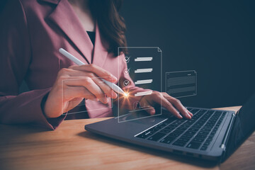 Businesswoman working on laptop with electronics document icons by virtual notebook screen using a stylus pen checking list on a digital tablet. E-document management Paperless workplace concept.
