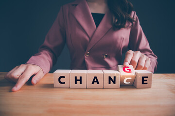 Businesswoman hand flipping wooden blocks with CHANGE to CHANCE text. Economy investment business crisis, technology transformation can make good chance, strategy, solution, positive thinking concept. - obrazy, fototapety, plakaty