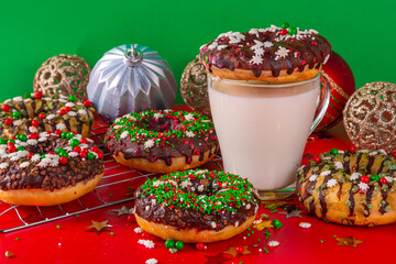 Bright festive decorated Christmas and New Year donuts set, with colorful red, green white snowflake sugar sprinkles. Sweet seasonal Christmas dessert
