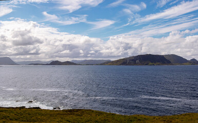 Blue cloudy sky over the fjords on a summer day