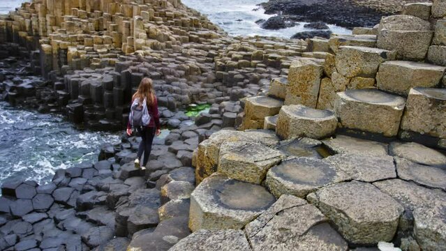 Giant's Causeway and Causeway Coast woman walking with backpack