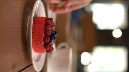 Fruit dessert served with a cup of coffee in a restaurant, close-up, selective focus - Powered by Adobe