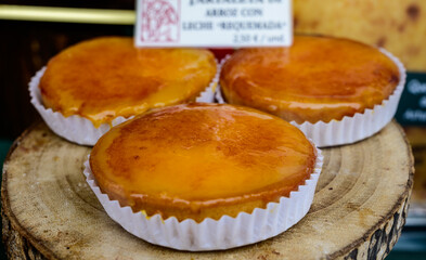 Fresh baked pastries and sweets on display in artisan Spanish confectionery shop, rice and milk cake