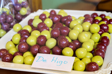 Sweet fruit candy beads in artisan Spanish confectionery shop, english translation: olives