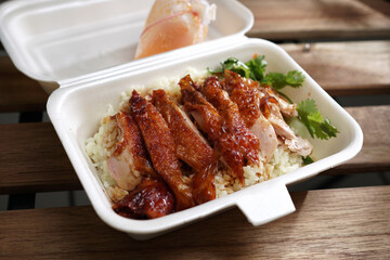 Malaysian take away local delicacy - Roasted Chicken Rice in polystyrene container. 