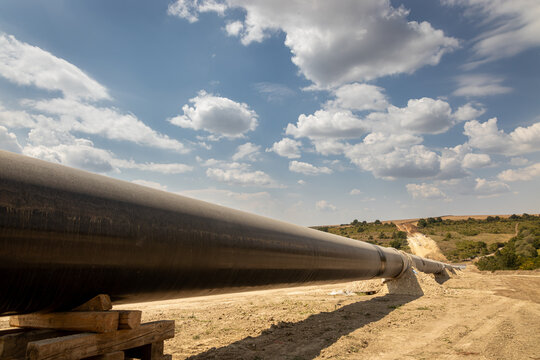 Gas and oil pipeline construction. Pipes welded together. Big pipeline is under construction. Cloudy sky