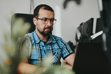 Portrait professional man programmer working concentrated on computer diverse offices. Modern IT technologies, development of artificial intelligence, programs, applications and video games concept