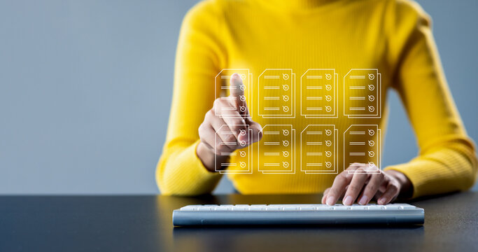 Document management concept with icons on virtual screen, ERP, Businesswoman working on keyboard laptop computer with electronics document