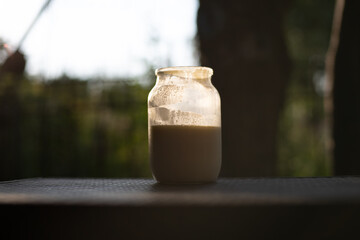 Whole milk. A glass jar with Non-Homogenized milk