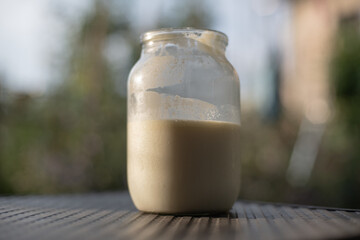 Whole milk. A glass jar with Non-Homogenized milk