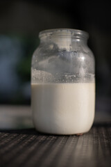 Whole milk. A glass jar with Non-Homogenized milk