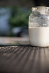 Whole milk. A glass jar with Non-Homogenized milk