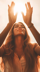 Beautiful woman praying holding her palm up above the head in front of the sun