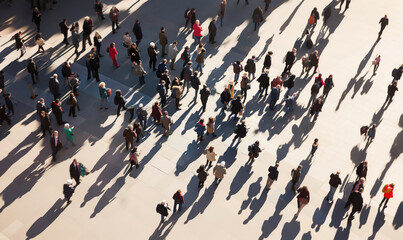 From highly above large crowd of people walking in sunny city square - Powered by Adobe