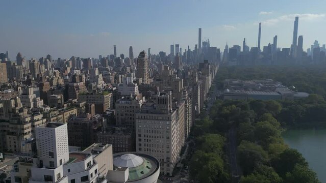 view of 5th Ave. descending into trees of Central Park in NYC