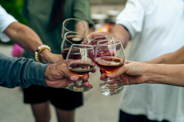 Home Garden BBQ Party, Wine Glasses Clink in Family Toast, enjoying harvest time together outside at front of house, grandfather and grandfather asian people, man and woman