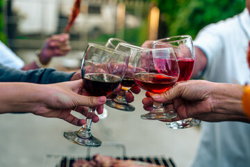 Home Garden BBQ Party, Wine Glasses Clink in Family Toast, enjoying harvest time together outside at front of house, grandfather and grandfather asian people, man and woman