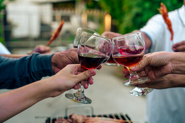Home Garden BBQ Party, Wine Glasses Clink in Family Toast, enjoying harvest time together outside at front of house, grandfather and grandfather asian people, man and woman