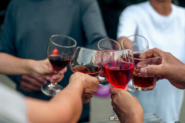 Home Garden BBQ Party, Wine Glasses Clink in Family Toast, enjoying harvest time together outside at front of house, grandfather and grandfather asian people, man and woman