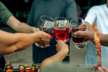 Home Garden BBQ Party, Wine Glasses Clink in Family Toast, enjoying harvest time together outside at front of house, grandfather and grandfather asian people, man and woman