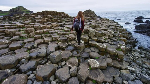 Woman hiking on Giants Causeway Ireland
