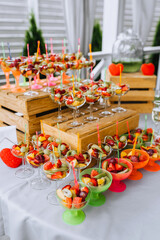 Fresh fruits are on the table, in a bowl at a banquet. Food photography, buffet.