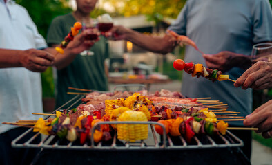 BBQ Fun Party with Grandparents, Family Gathering in the Garden, Summertime with grandpa, grandma, father and mother, BBQ Grill