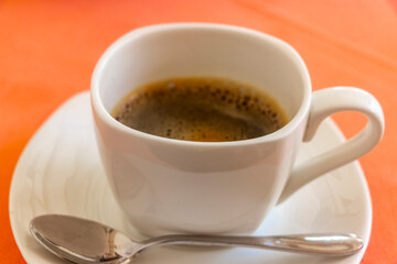 Cup with black coffee in resort Rasdhoo Atoll island Maldives.