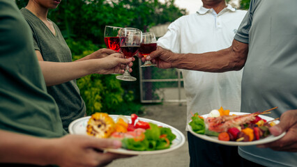 Home Garden BBQ Party, Wine Glasses Clink in Family Toast, enjoying harvest time together outside at front of house, grandfather and grandfather asian people, man and woman