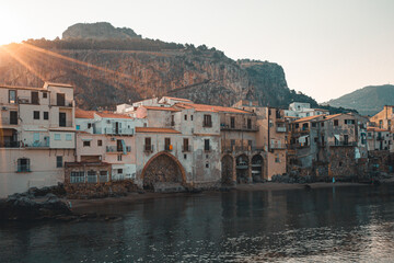 Fototapeta na wymiar Old Italian houses at the Waterfront of cefalu beach. Sicily