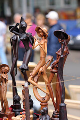 Fototapeta na wymiar Wooden handmade mini sculptures put up for sale during street fair