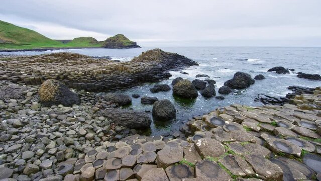 Shoreline pushing in at Giants Causeway Ireland with waves crashing lightly