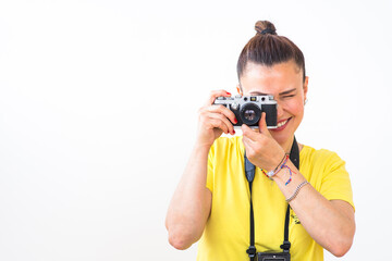 A female photographer using a vintage 35mm film rangefinder camera. A happy smile, enjoying photography.  Concept, retro, film photography, left side copy space.