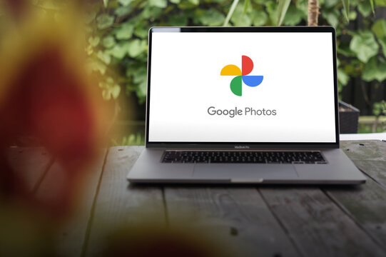 Google Photos logo, a photo sharing and storage service developed by Google, displayed on a MacBook Pro screen