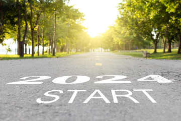 2024 Happy New year background. Start straight concept. word 2024 and Start written on the road at sunset. planning and challenge or career path,business strategy, opportunity and change. 2023 to 2024