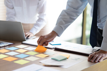 manager and businesswoman Picking ideas on a sticky note