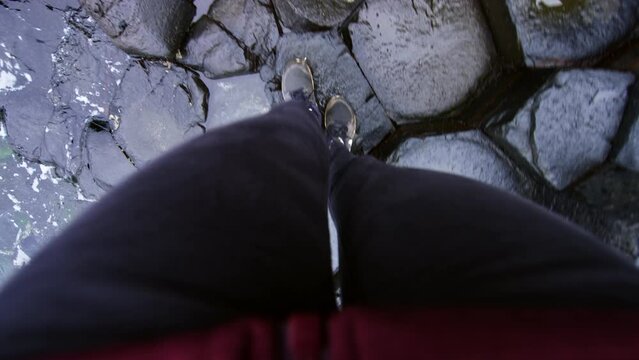 Point of View of woman walking on shoreline. Giant Causeway Ireland