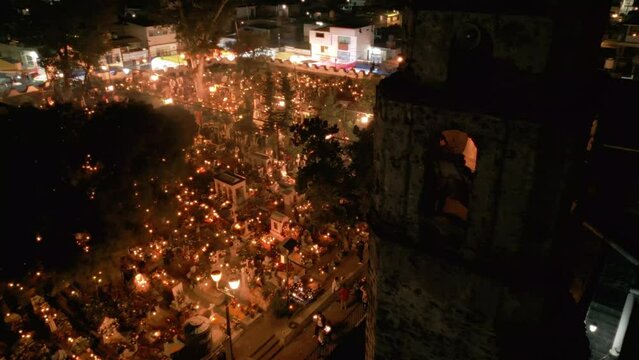 high angle view of a church in a well lit cemetery during day of the dead in Mexico