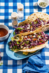 Tacos with roasted chiken with cabbage, salad, feta cheese and sauce - 644978520