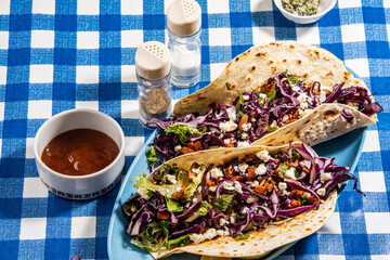 Tacos with roasted chiken with cabbage, salad, feta cheese and sauce - 644978532