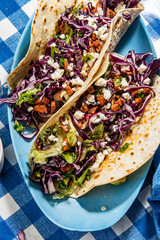 Tacos with roasted chiken with cabbage, salad, feta cheese and sauce - 644978541