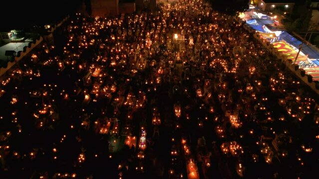 Flying over a well lit cemetery during day of the dead in Mexico