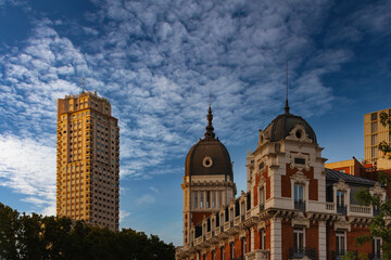 Fototapeta na wymiar A stunning view of old buildings in the city of Madrid, Spain, bathed in the warm glow of the evening sun under a beautiful blue sky