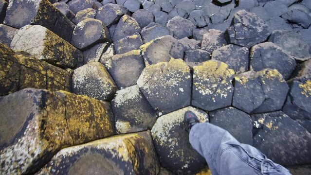 Walking towards ocean from point of view. Ireland Giants Causeway