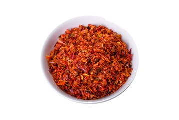 Paprika spice with smoked tomatoes crushed in a white saucer