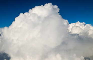 Naklejka na ściany i meble Beautiful Fluffy White and Gray Cumulonimbus Clouds on Blue Sky