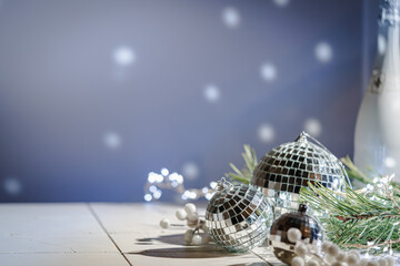 Silver Christmas balls amd snowflakes on shiny background. Christmas greeting card with copy space.