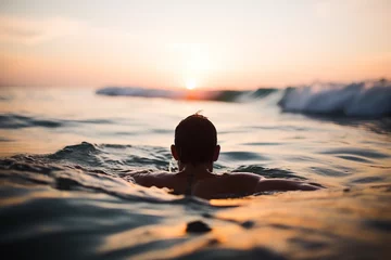 Fototapeten man swim in the middle of the sea © Ydhimas