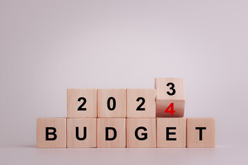 2024 Budget planning and allocation concept. Wooden cube flips and changes the inscription "BUDGET 2023" to "BUDGET 2024" on white background, Copy space. Use for banner and presentation.